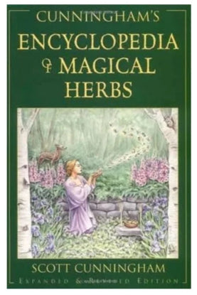 Cunningham's Encyclopedia of Magical Herbs: the cover is a deep green with a picture of a woman in a garden with flowers and butterflies around her. 