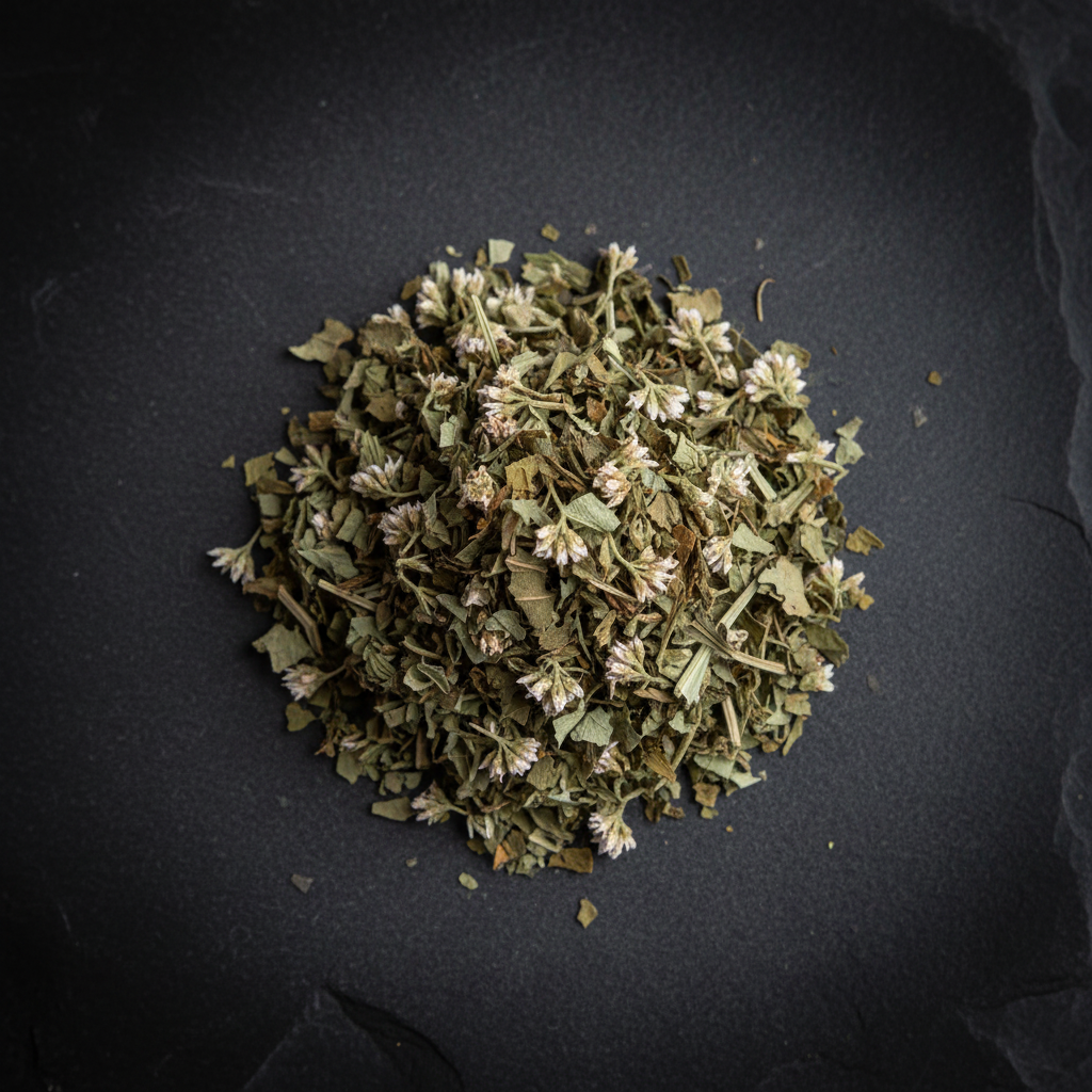Dried boneset herb on a dark stone slab